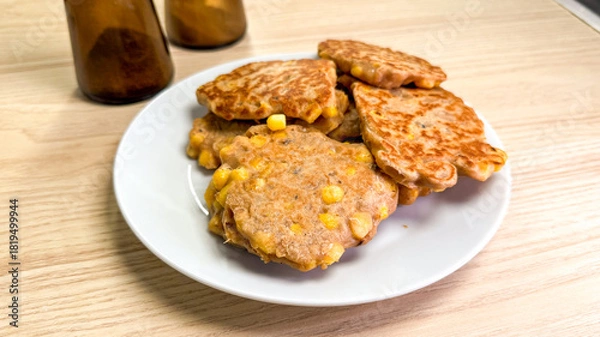 Obraz Golden corn fritters nestle on a plate, embracing rustic harvest vibes, ideal for Farm-to-Table Day indulgence
