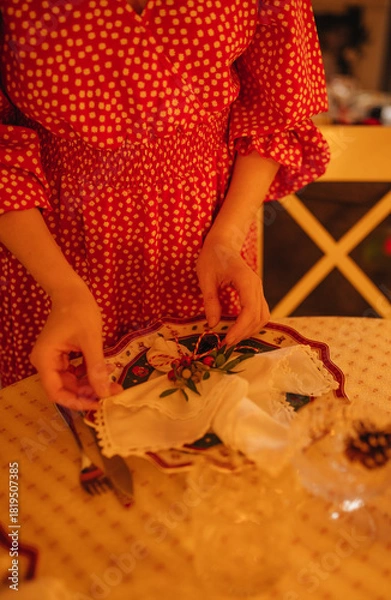 Obraz the hand of a woman setting the table for Christmas dinner