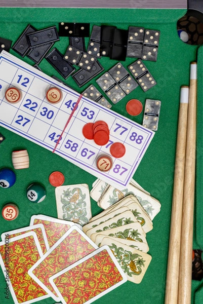 Fototapeta Collection of classic board games, scattered haphazardly on table, perfect for game nights and leisure time. Top view