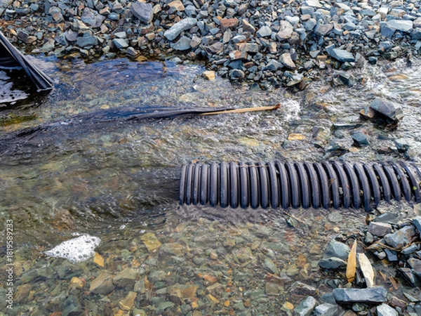 Fototapeta Flood damage on a small river caused by heavy rain and an undersized culvert.