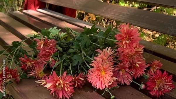Obraz Beautiful arrangement of pink flowers and greenery resting on a wooden bench in a tranquil park setting