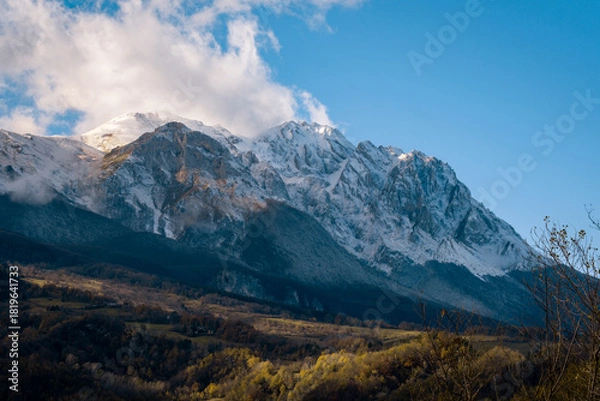 Obraz Snow-capped Gran Sasso d'Italia mountains glowing under sunlight with autumn colored valley below