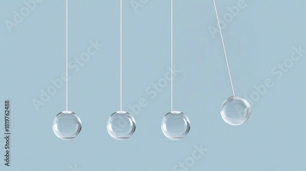 Fototapeta Newton cradle balls in motion against a light blue background  