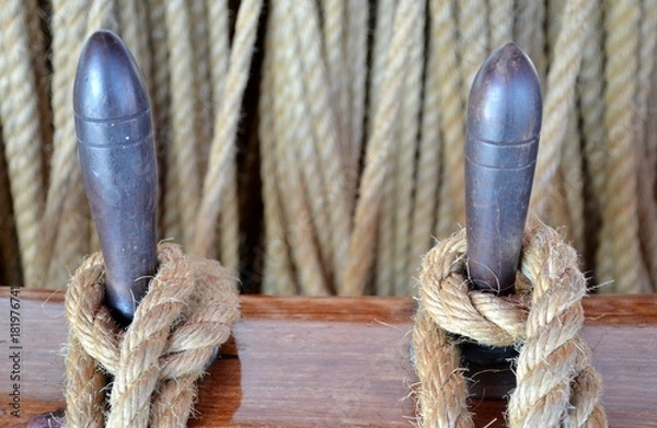Fototapeta Details of tied rope from boat and wooden tools with background