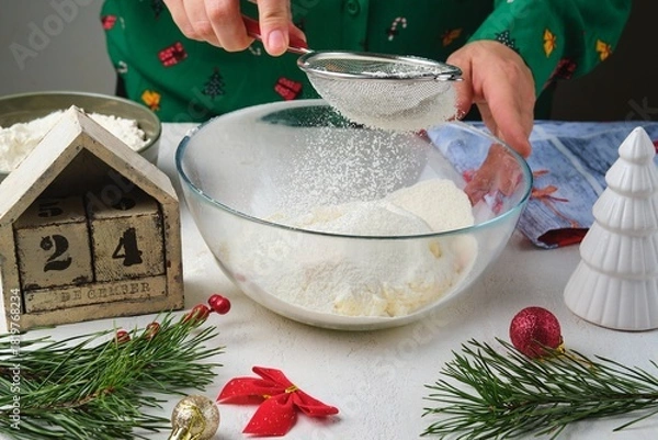 Fototapeta Step-by-step preparation of Candy Cane shortbread cookies in Christmas decor on a light concrete background. Merry Christmas! Traditional Christmas treats