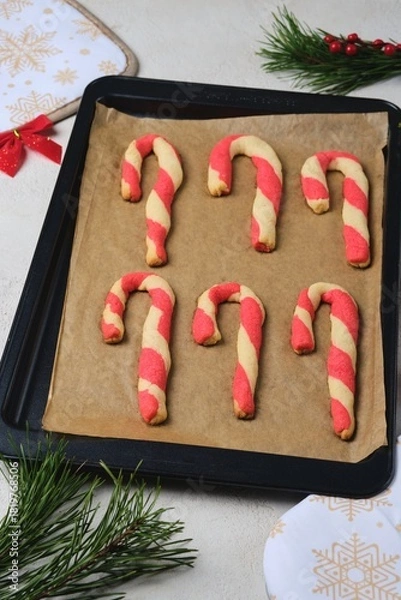 Fototapeta Step-by-step preparation of Candy Cane shortbread cookies in Christmas decor on a light concrete background. Merry Christmas!
