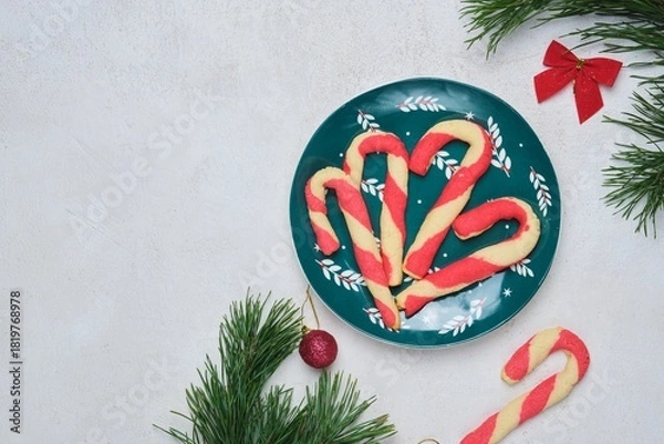 Obraz Christmas candy cane shortbread cookies on a green plate with Christmas decor against a white concrete background. Merry Christmas.