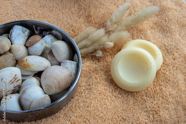 Fototapeta Spa still life with natural round soap bars, seashells and dried pampas grass on a soft orange towel, evoking serene, organic self care and relaxing bathroom ritual
