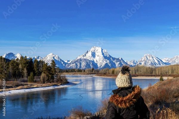 Fototapeta Woman admiring view of Mount Moran at Grand Teton National Park from Oxbow Bend with Sun Spikes