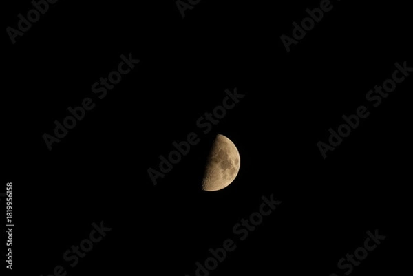 Obraz A detailed photograph of the moon captured on August 31, 2025, at 9:34 p.m. Eastern Time, showing the illuminated last-quarter lunar surface against a dark sky.