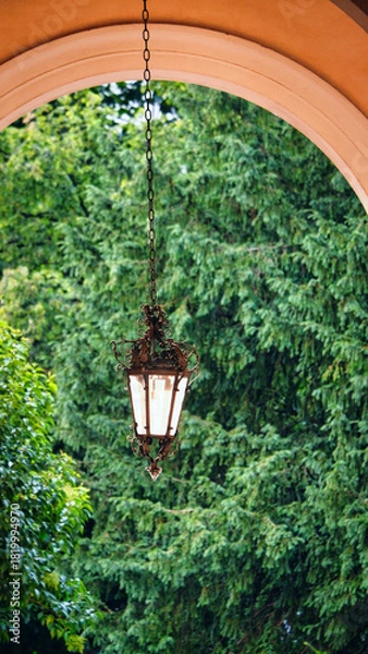 Obraz Lantern hanging from the arch of a historic building