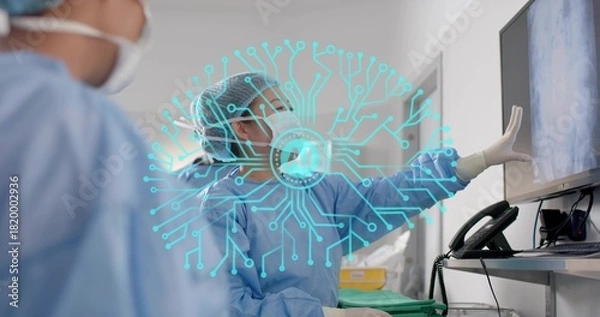 Fototapeta Pointing doctor in gown and mask reviewing monitor with AI overlay, green tray, operating room