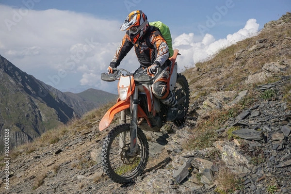 Fototapeta Enduro journey with dirt bike high in the mountains