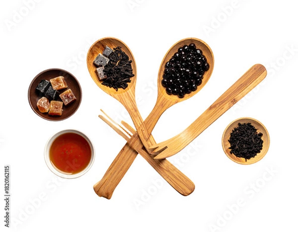 Obraz Tea ingredients artfully arranged on a black background, featuring wooden utensils and bowls