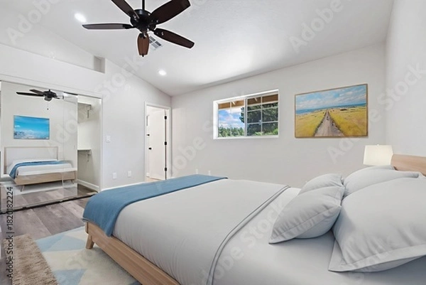 Obraz There is a spacious bedroom that features a large bed and a ceiling fan