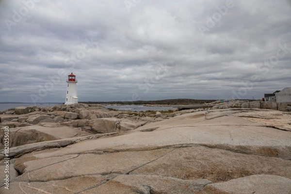 Obraz Peggy's Cove Lighthouse stands as a timeless beacon against the rocky shores of Nova Scotia's picturesque coastline.