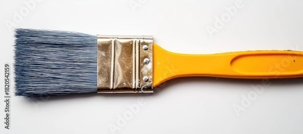 Obraz Blue-tipped paintbrush with yellow handle, close-up