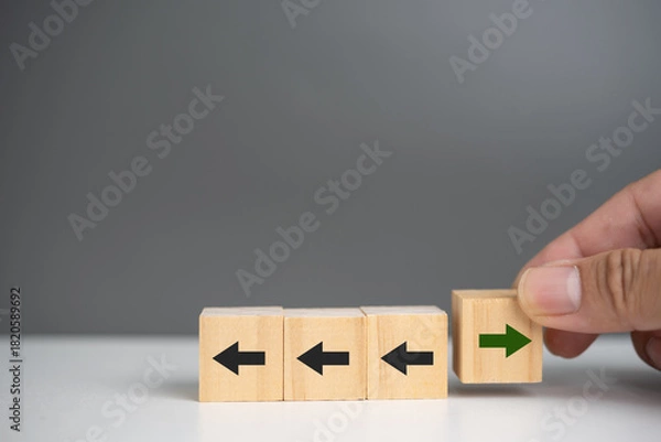 Fototapeta New ways of working, differentiation strategy concept symbol on wood blocks. Providing uniqueness, different and distinct from competitors, creating competitive advantage. Business direction concept
