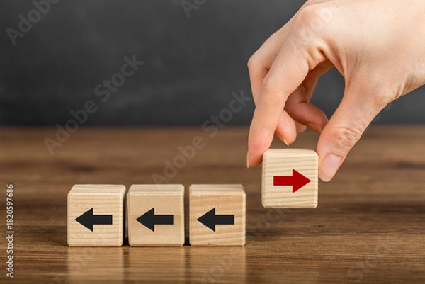 Fototapeta New ways of working, differentiation strategy concept symbol on wood blocks. Providing uniqueness, different and distinct from competitors, creating competitive advantage. Business direction concept.