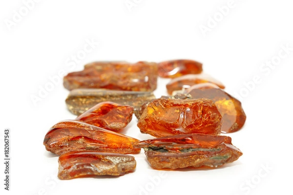 Fototapeta Amber red in perspective with a bokeh effect on a white background. Amber background and texture. Background for jewelry stores and advertising jewelry. Sunstone is a natural jewelry mineral. Red 