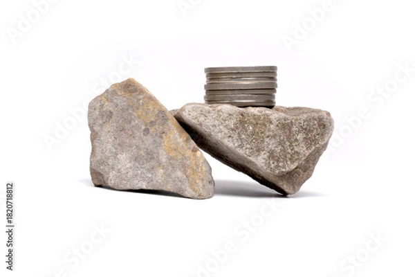 Fototapeta Balancing silver coins on rough stone financial concept