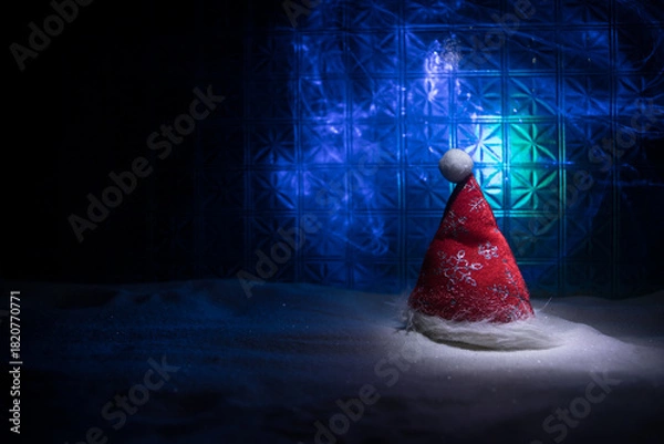Fototapeta Christmas home decoration with snow and tree on a dark background with copy space. Selective focus. New Year attributes on background