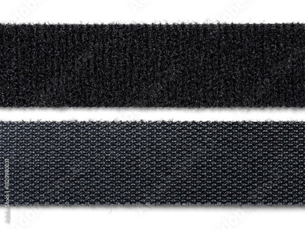 Fototapeta A stack or roll of black reusable hook-and-loop straps, commonly used as cable ties or cord organizers. Essential for IT, home organization, and technology concepts.