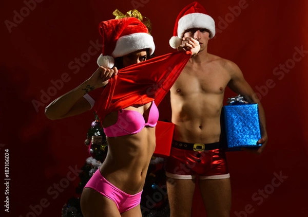 Fototapeta New year guy and girl on red background.