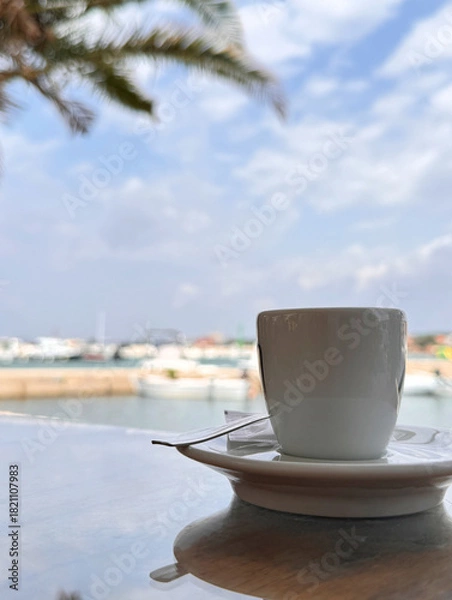Obraz close up cup of coffee on table at a cafe view on the beach in Dalmatia, Croatia