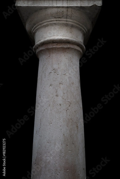 Obraz Ancient really stone neoclassical column against black background. Aged stone texture.
