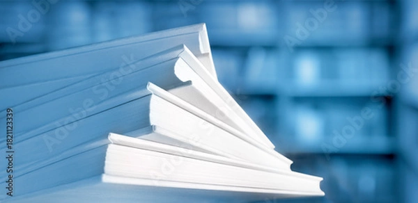 Obraz Shallow and soft focus against macro view of stack of books with unfocused library background in blue color
