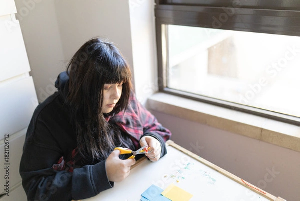 Fototapeta Young person enjoying paper crafting hobby at home