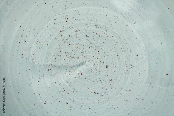 Fototapeta Mottled enamel texture on a clay plate