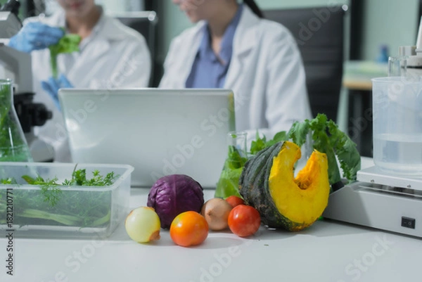Obraz Two Asian female scientists analyze plant and meat samples in a modern laboratory, using microscopes and documenting results to improve food quality, safety, biotechnology,agricultural innovation
