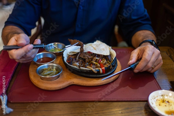 Obraz Man Eating Sizzling Meat and Vegetables