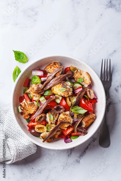 Fototapeta Italian panzanella with anchovies, olives and tomatoes.