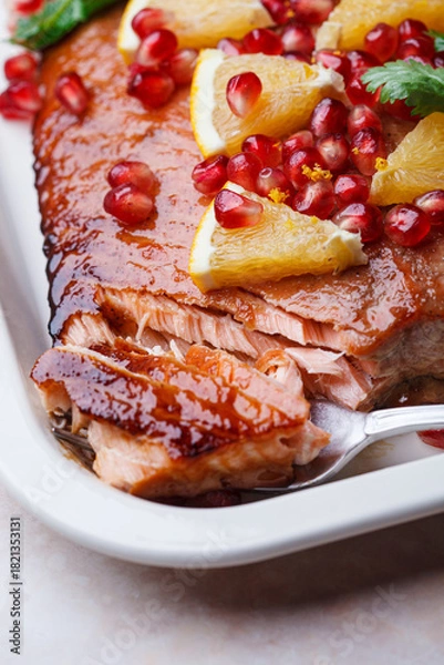 Fototapeta Christmas salmon in pomegranate juice with orange and pomegranate seeds.