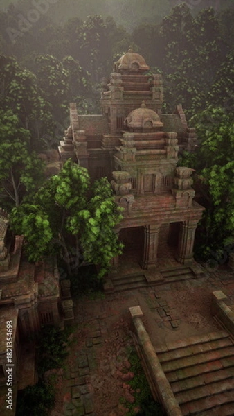 Fototapeta Aerial view of an old temple nestled among lush trees in the Cambodian jungle.