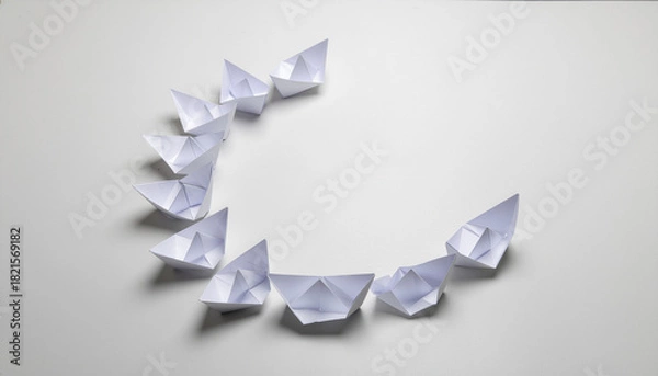 Obraz Strategic paper boats arranged in circle symbolize peace and dialogue on white background with soft lighting