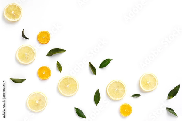 Obraz  Pattern of fresh fruits on a white background, top view, flat lay. Composition of green leaves and slices of citrus fruits: lemon, mandarin. Healthy food background, wallpaper, collage.