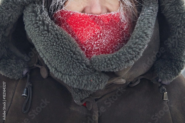Fototapeta Frosty breath, part of a woman's face in winter with frost