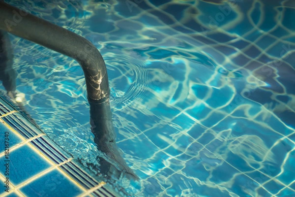 Obraz Grab bars ladder in the blue swimming pool