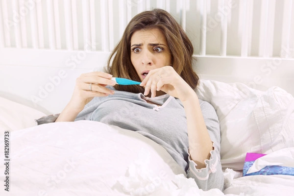 Obraz Woman scared about high temperature flue in bed