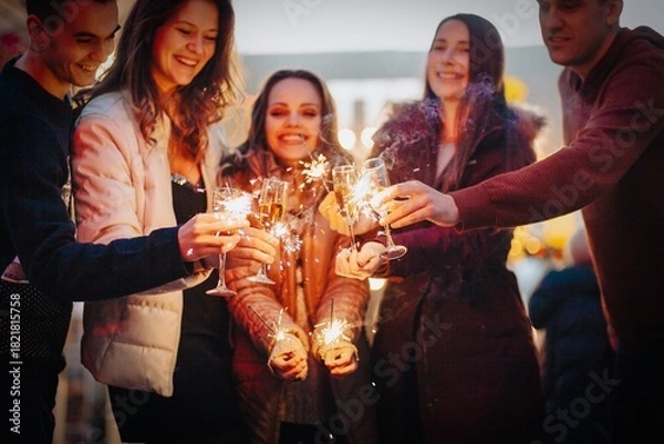 Obraz Group funny people winter holidays. Christmas concept with firework sparkler