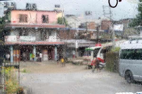 Obraz Blurred street scene through car windows with rain drop in Nepal