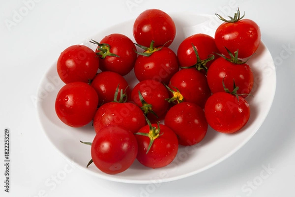 Obraz Plate with tomatoes on white
