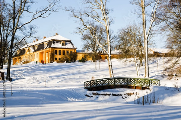 Fototapeta Wooded arch footbridge on a snow covered landscape. Bogstadvannet area in Oslo Norway