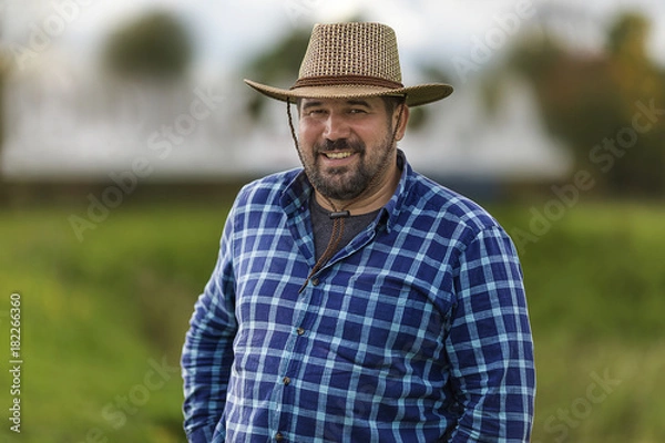Obraz bearded brutal macho in cowboy hat ulybayutsya and happy life, full of positivity and optimism and is confident in the future
