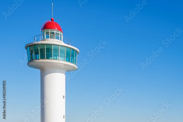 Obraz White Coastal Lighthouse Tower Under Clear Blue Sky