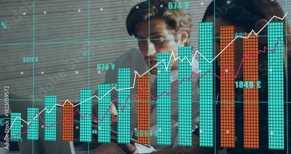 Obraz Reviewing two professionals in shirts leaning over laptop in office, finance charts and coffee